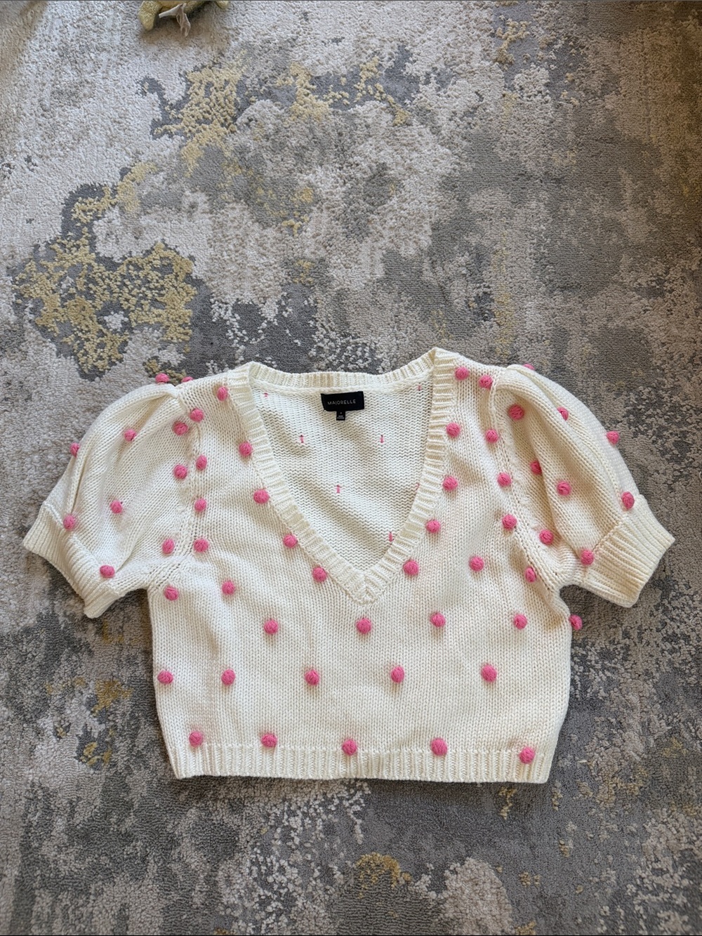 Revolve Majorelle Cream V‑Neck Cropped Sweater with Pink Pom Poms